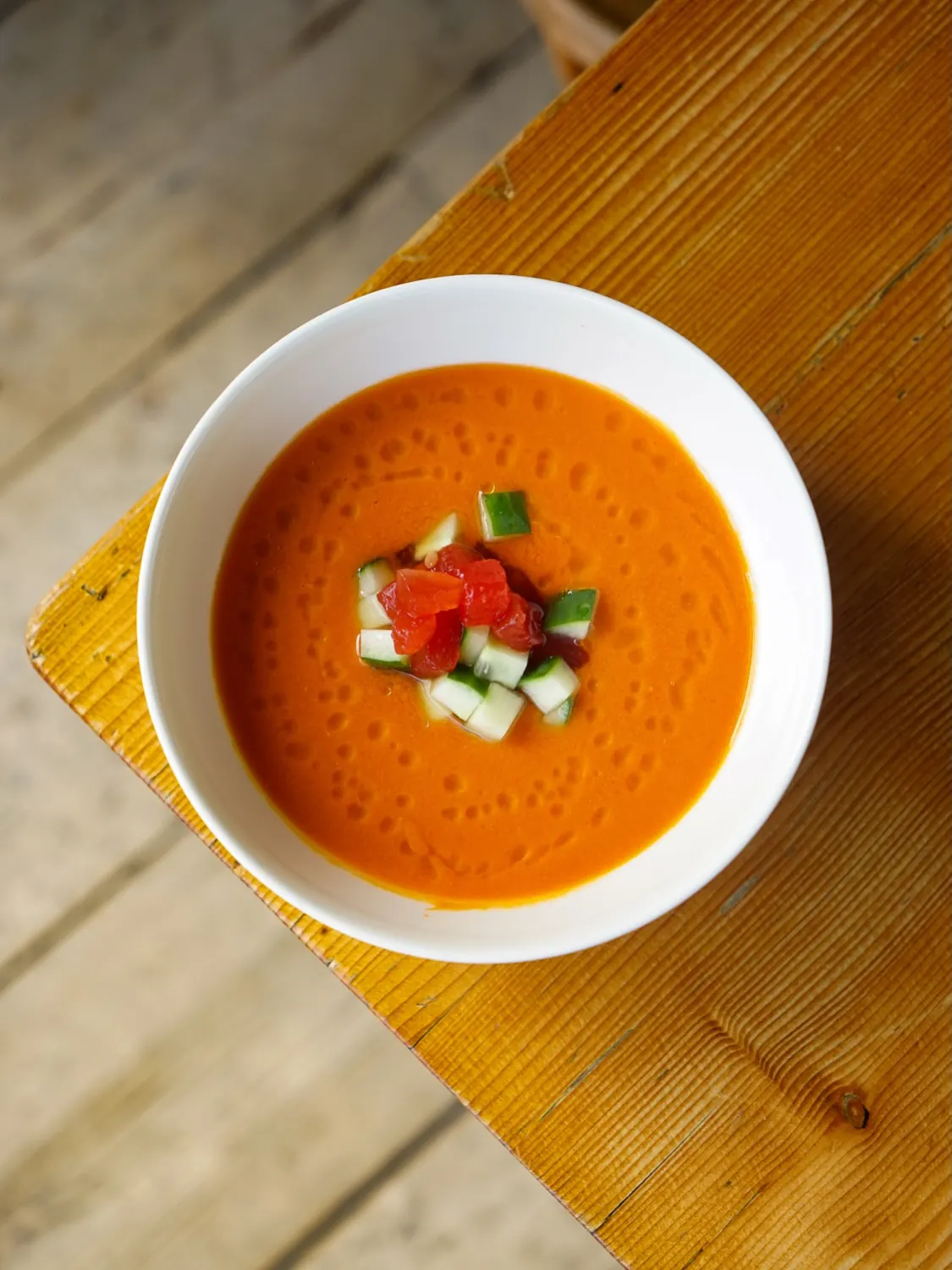 chilled tomato soup with cucumber, seen from above